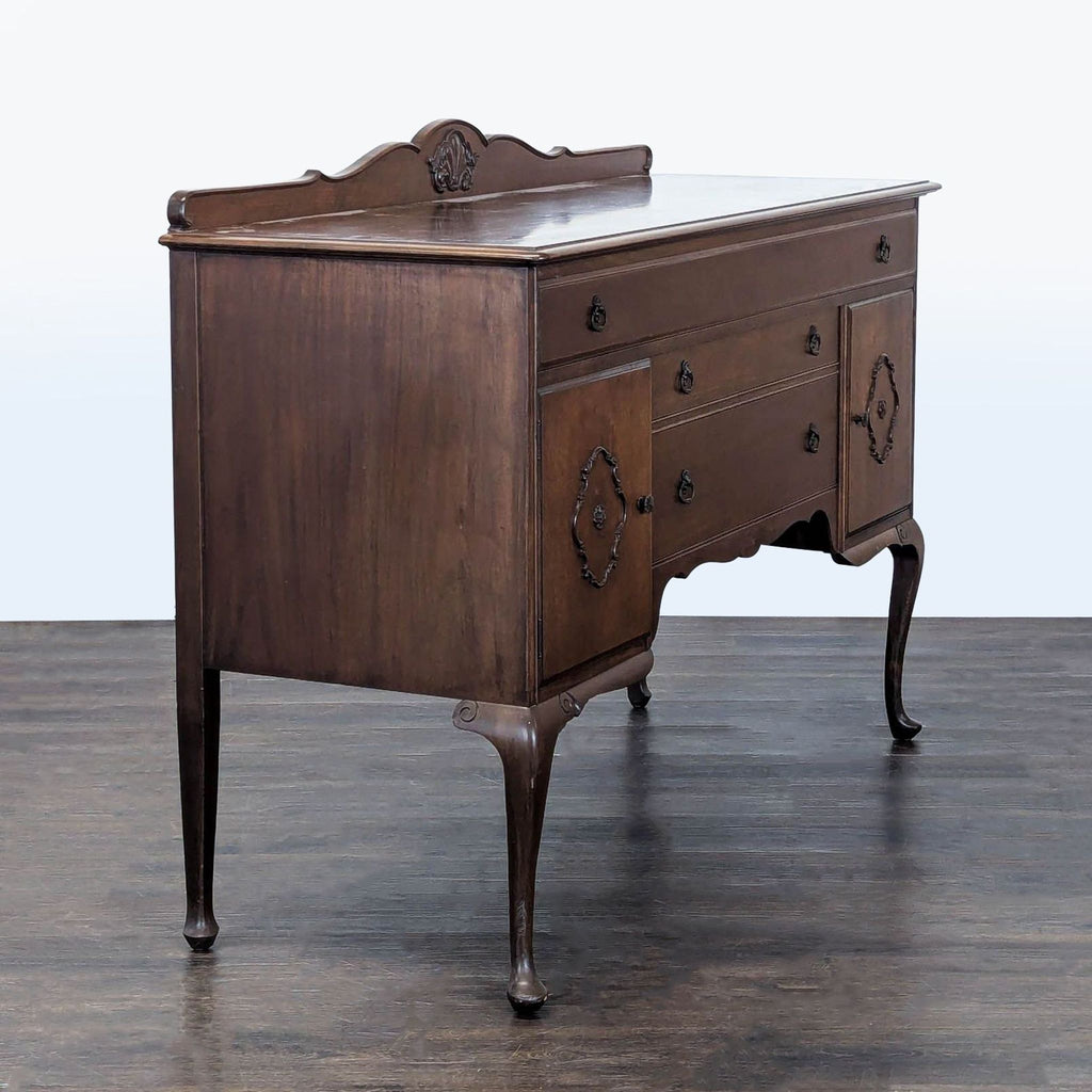 Traditional sideboard featuring cabriole legs, detailed carving, spacious drawers, and dual cabinets.