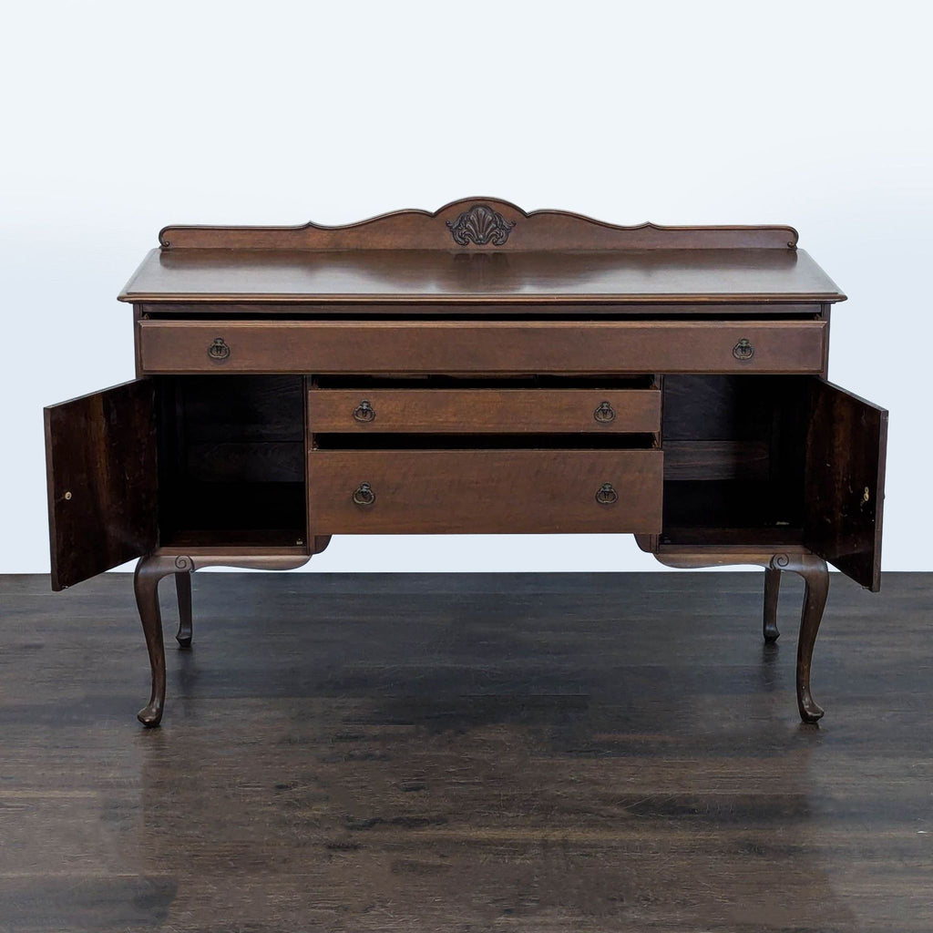 Elegant credenza with solid wood build, ornate carvings, three central drawers, and two cabinet doors.  