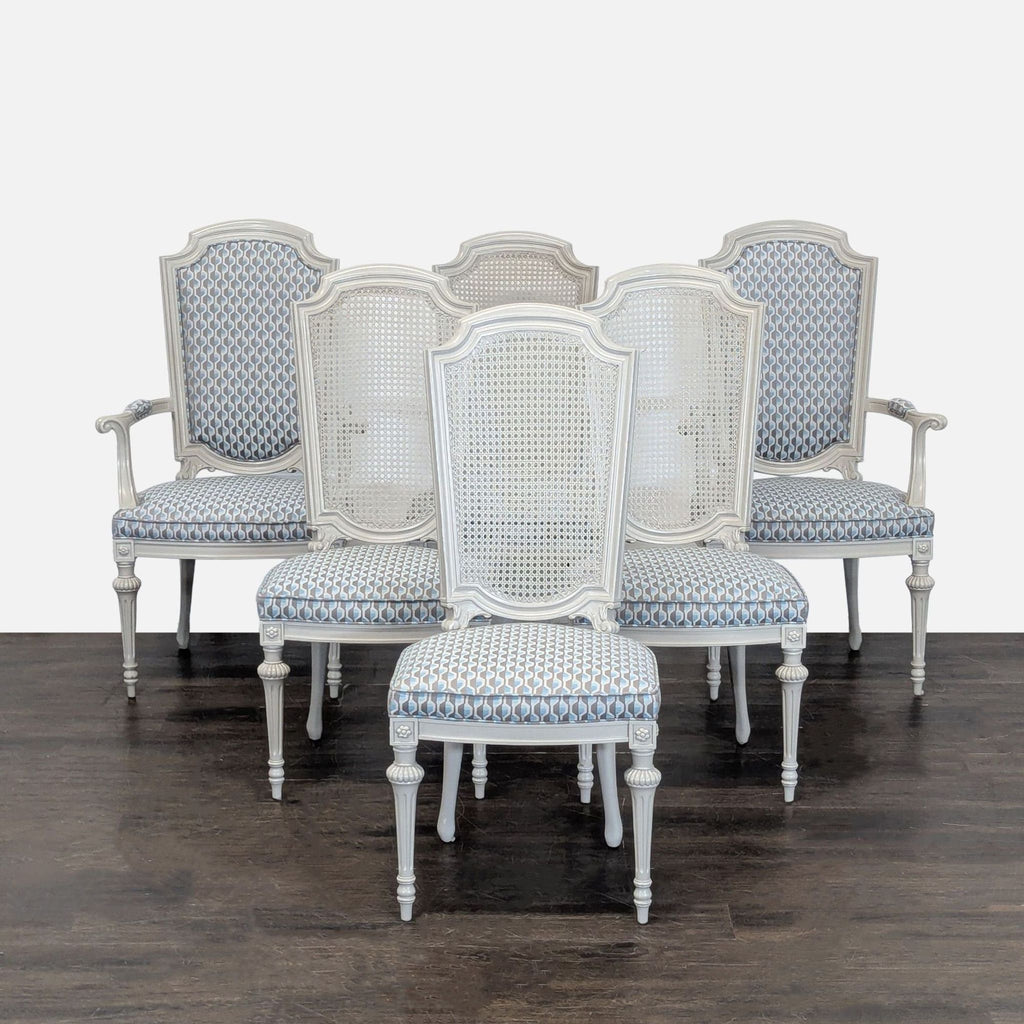 Set of six carved dining chairs: four with cane backs and two armchairs with upholstered backs and arms.