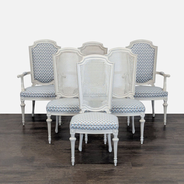 Set of six carved dining chairs: four with cane backs and two armchairs with upholstered backs and arms.