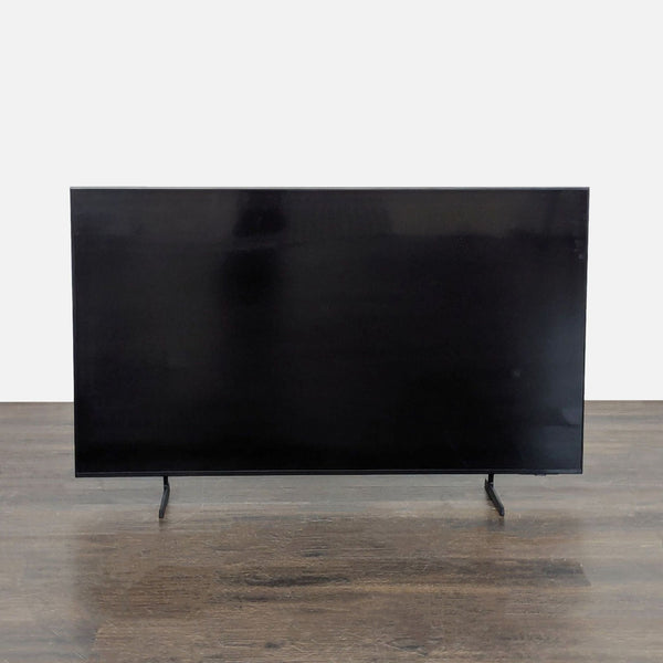 Samsung 55-inch smart TV with a slim design, setup screen visible, remote and stand included.  