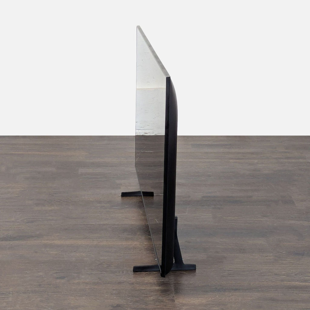 Modern 55-inch Samsung TV on stand, displaying clear on-screen setup with QR code for easy connection.