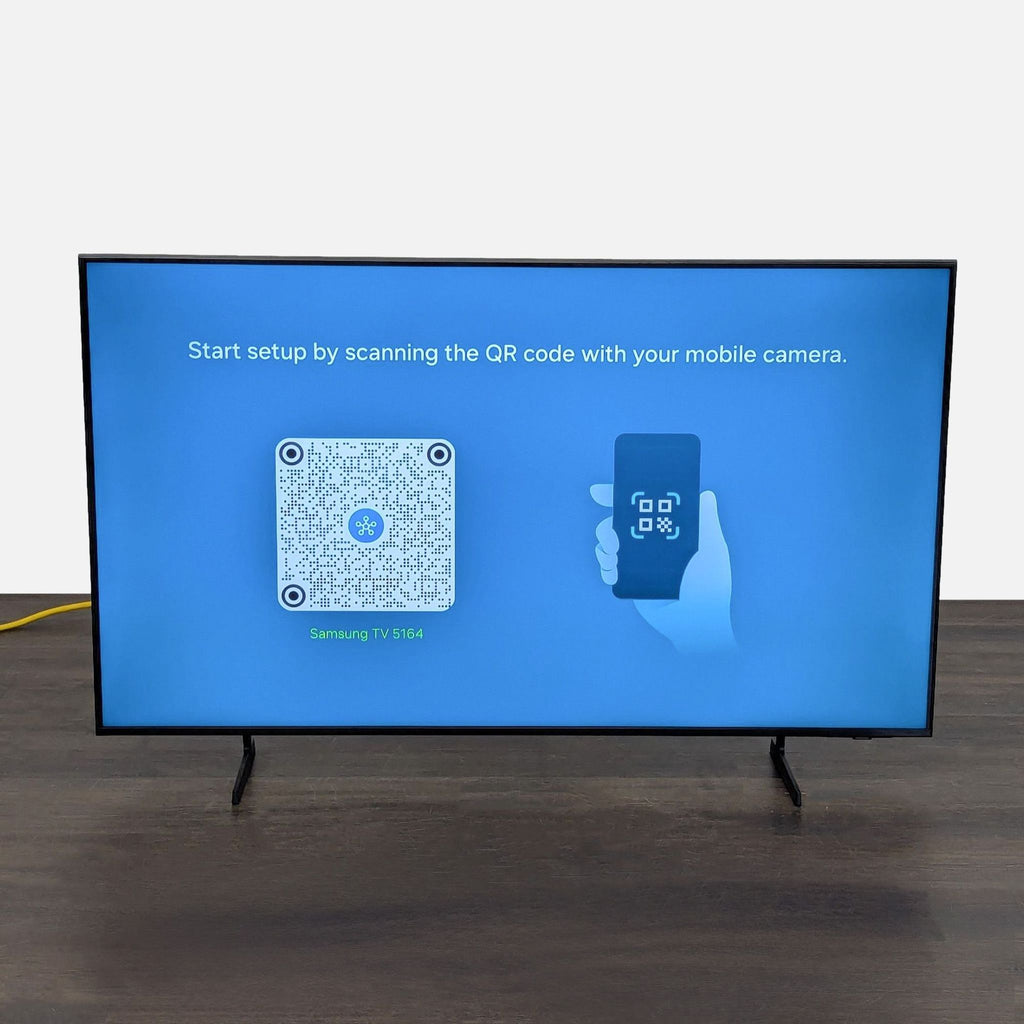 Samsung smart TV in excellent condition, showing clear setup instructions with remote and stylish modern stand.