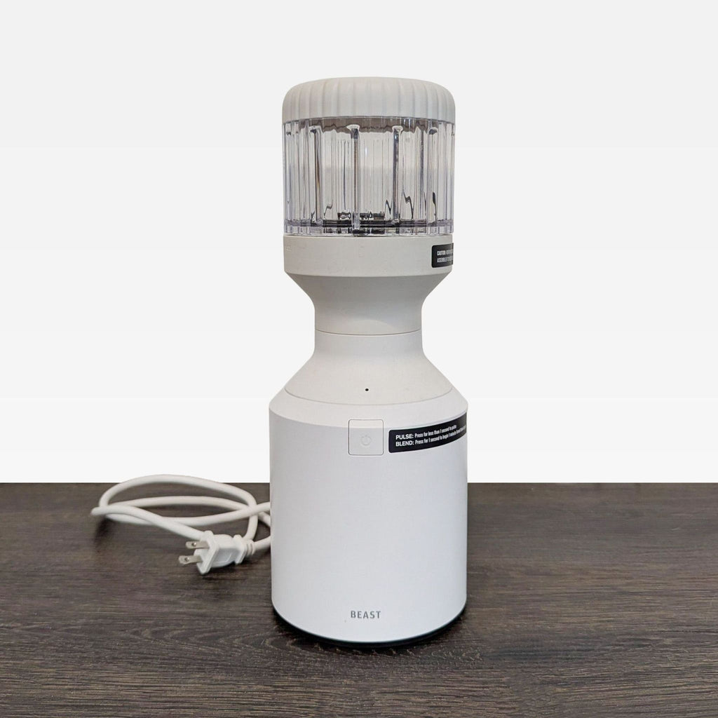 Beast mini blender with clear jar, compact design, and single button for easy countertop blending.