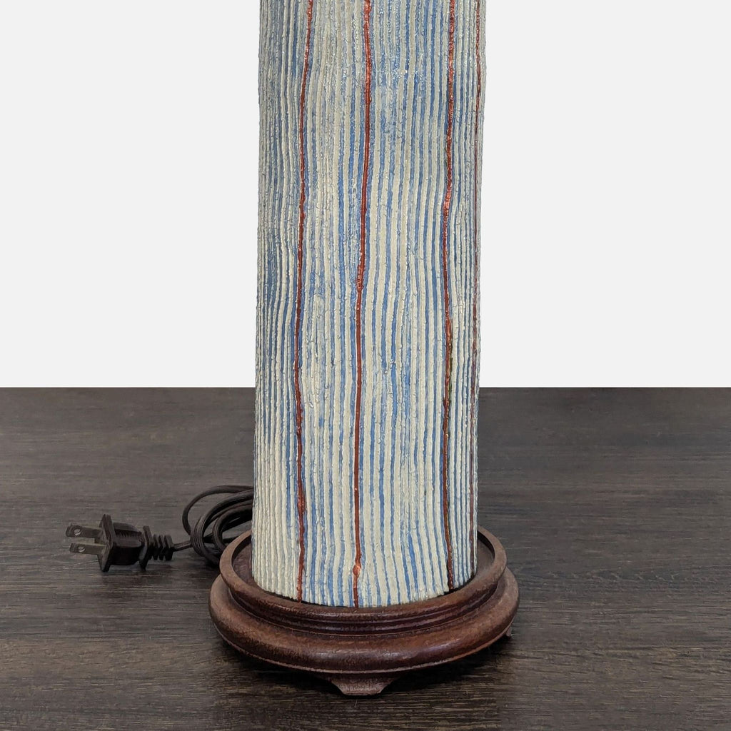 Contemporary lighting: lamp with striped ceramic base and neutral beige shade, ideal for ambient home lighting.