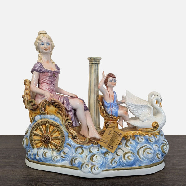 Porcelain Capodimonte sculpture of a lady in a chariot with a cherub and swan, featuring intricate painted details.