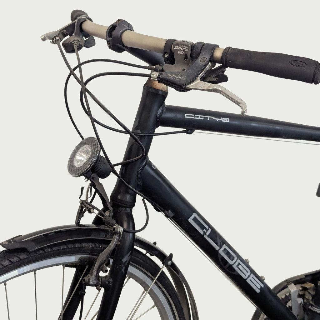 Specialized Globe commuter bike ready for city rides, equipped with kickstand, rear rack, and fenders.