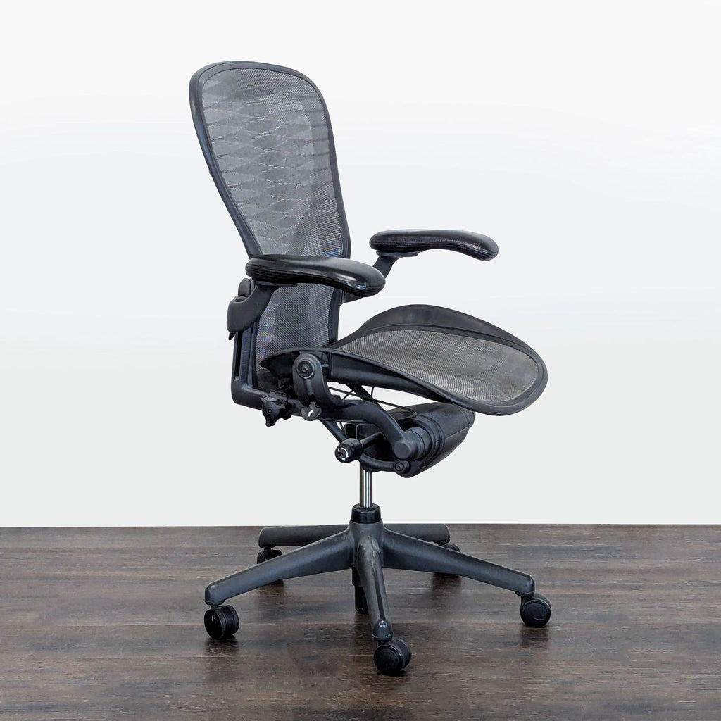 1. Modern Herman Miller chair with contoured seat, shown in a minimalist setting.