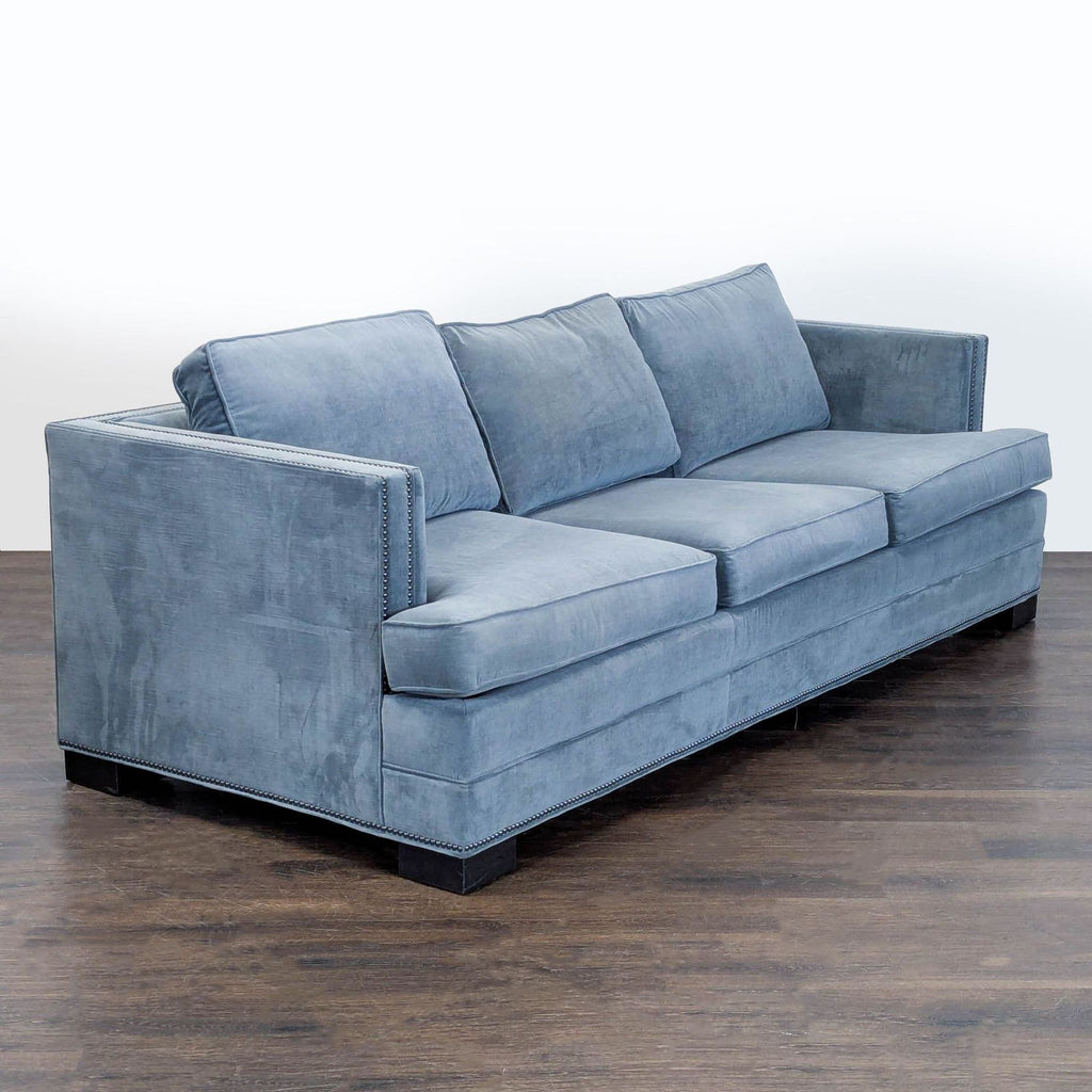 Elegant blue sofa by Ethan Allen, featuring wide seats, decorative nailhead arms, and soft, comfortable fabric.  