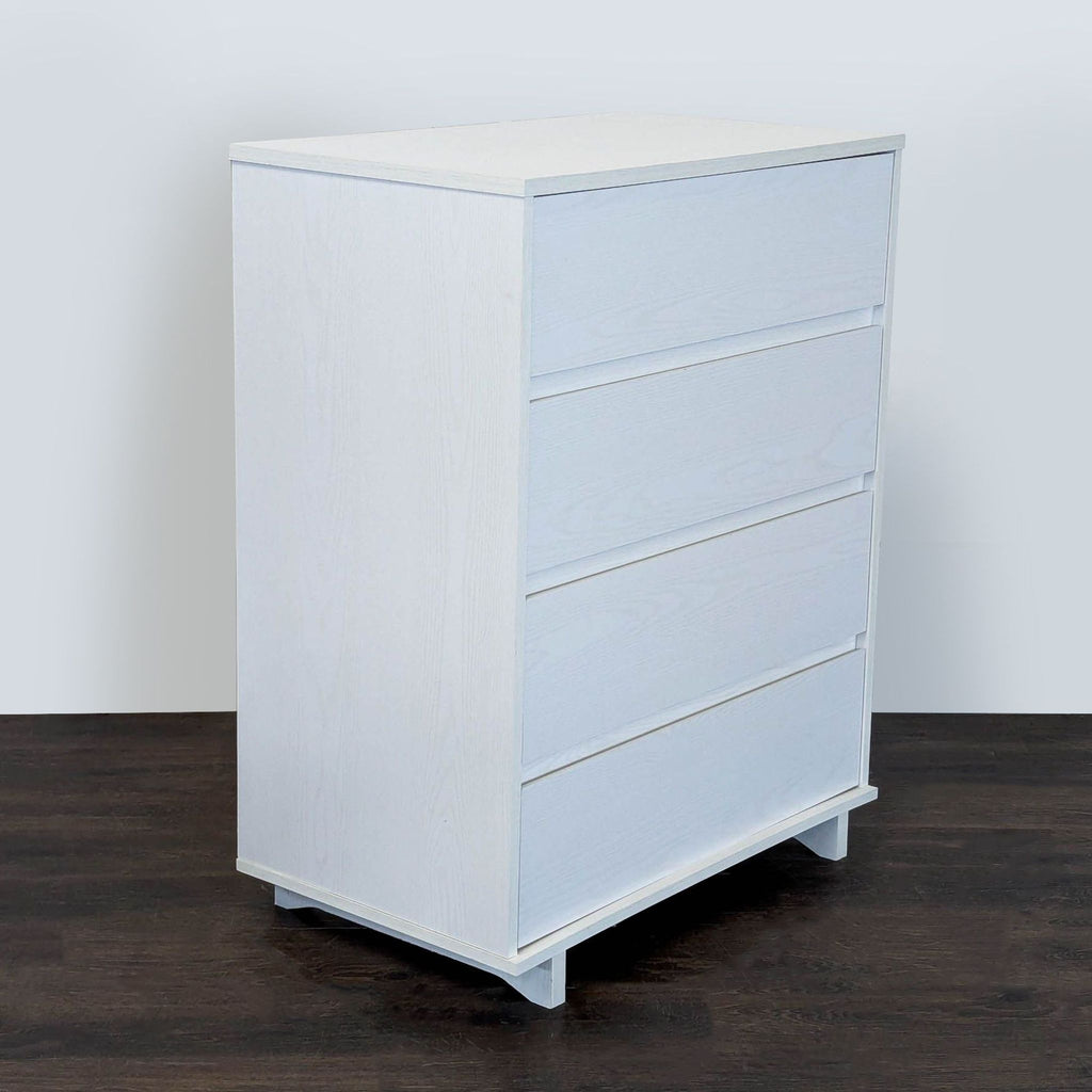 Target Room Essentials dresser in white; sleek, sturdy, and functional with four large storage drawers.