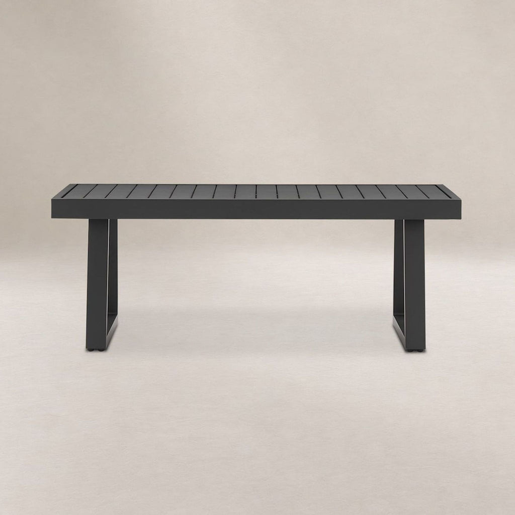 Castlery black metal table with slatted top and strong legs, suitable for modern indoor or outdoor spaces.