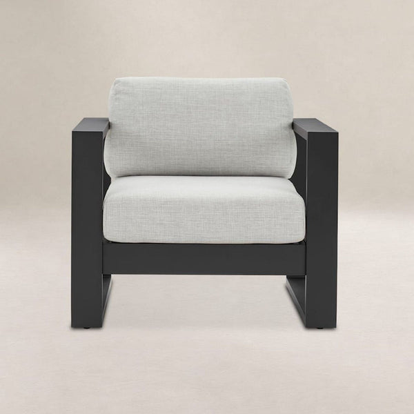 Castlery chair with black metal frame and light grey cushions, ideal for relaxing in modern spaces.  