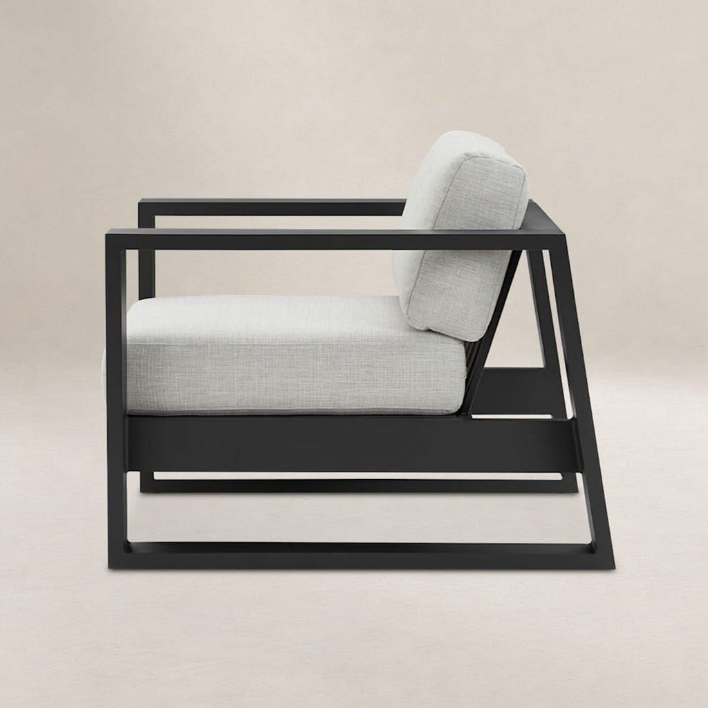 Modern Castlery chair featuring thick grey cushions and a sturdy black frame, perfect for living rooms.  