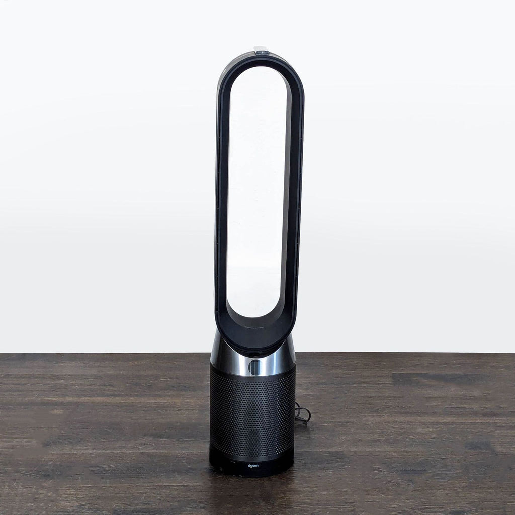 Modern Dyson air purifier and fan, bladeless, quiet black-silver unit for improved air quality and cooling.