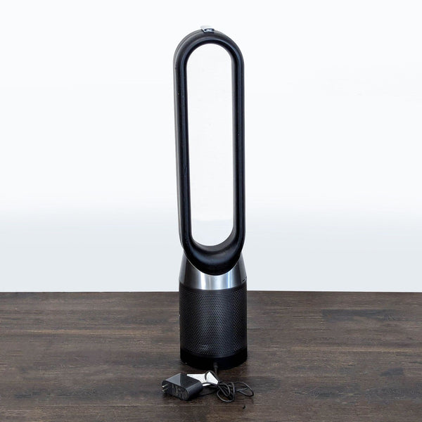 Dyson Pure Cool Link tower fan and air purifier, bladeless, black and silver, sleek modern design.