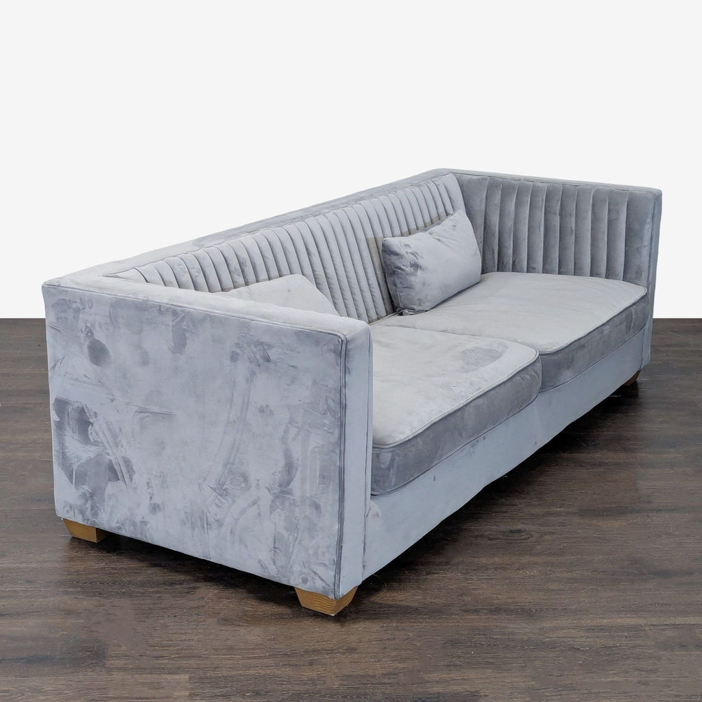 Modern 3-seat grey velvet sofa by Alder & Tweed, featuring channel-tufted back, deep seats, and wood legs.
