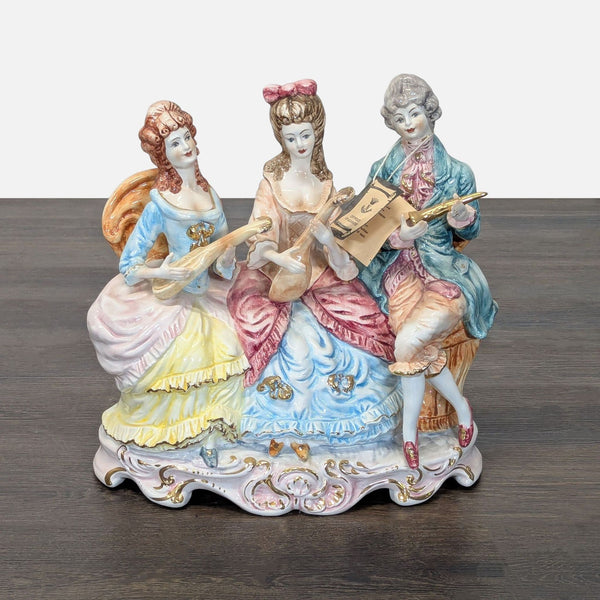 Capodimonte porcelain sculpture of three figures in elegant classical dress playing musical instruments together.