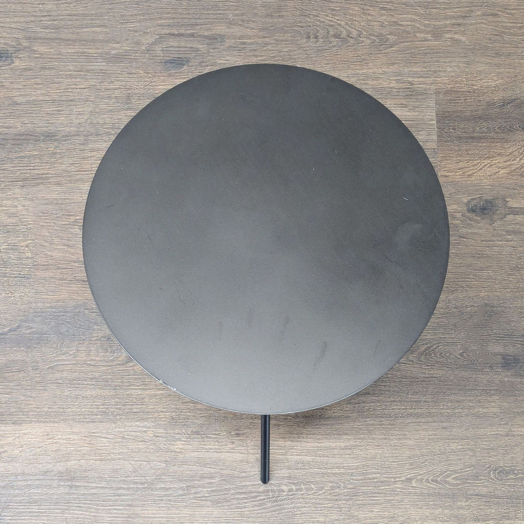 EQ3 brand end table with a minimalist sheet metal surface and sturdy stainless steel legs.  