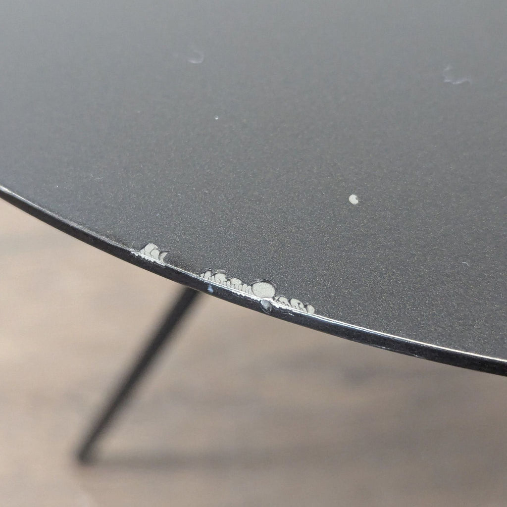 Contemporary end table by EQ3, combining a metallic top with a stainless steel frame.