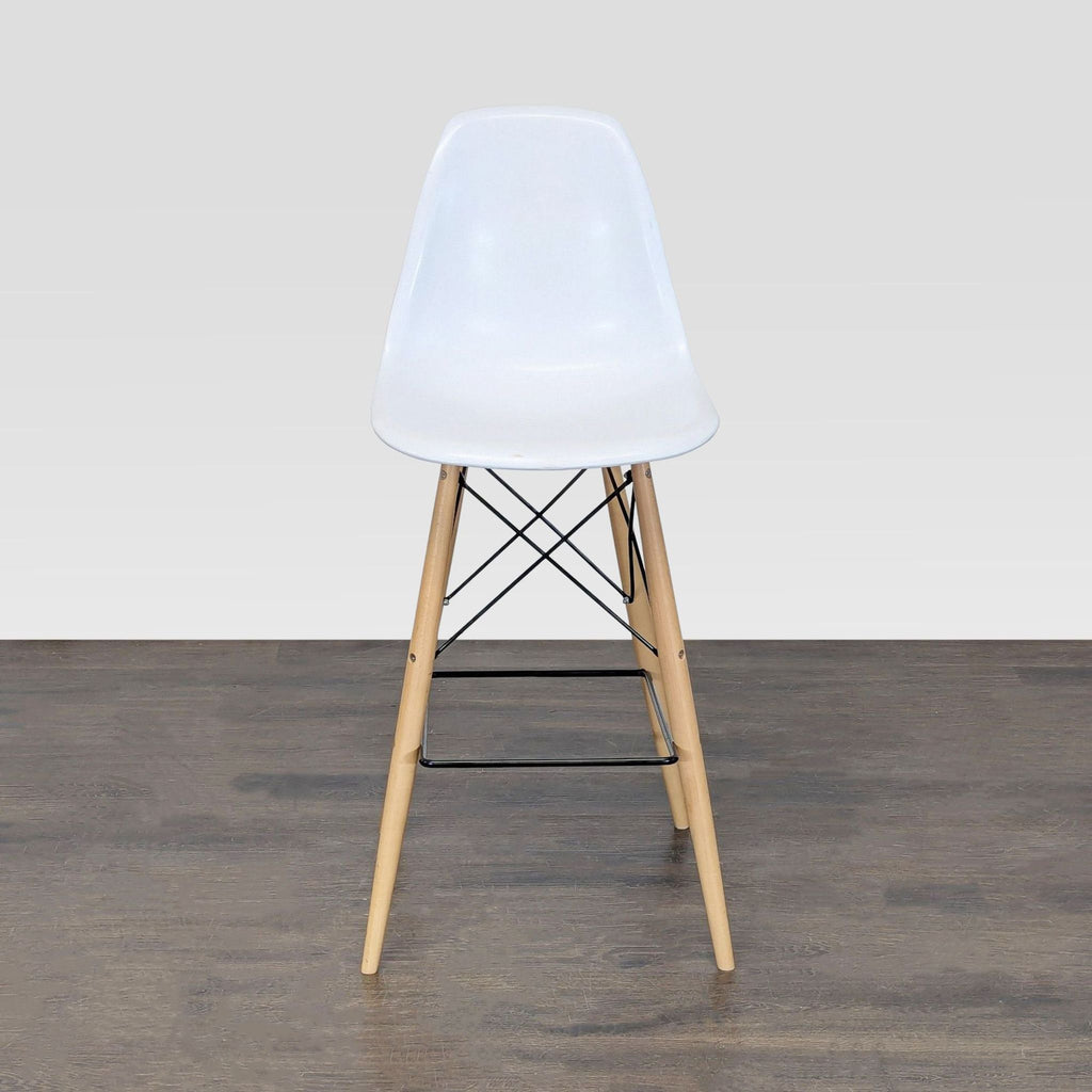Contemporary dining chair featuring an ergonomic plastic shell seat and sturdy wooden legs.