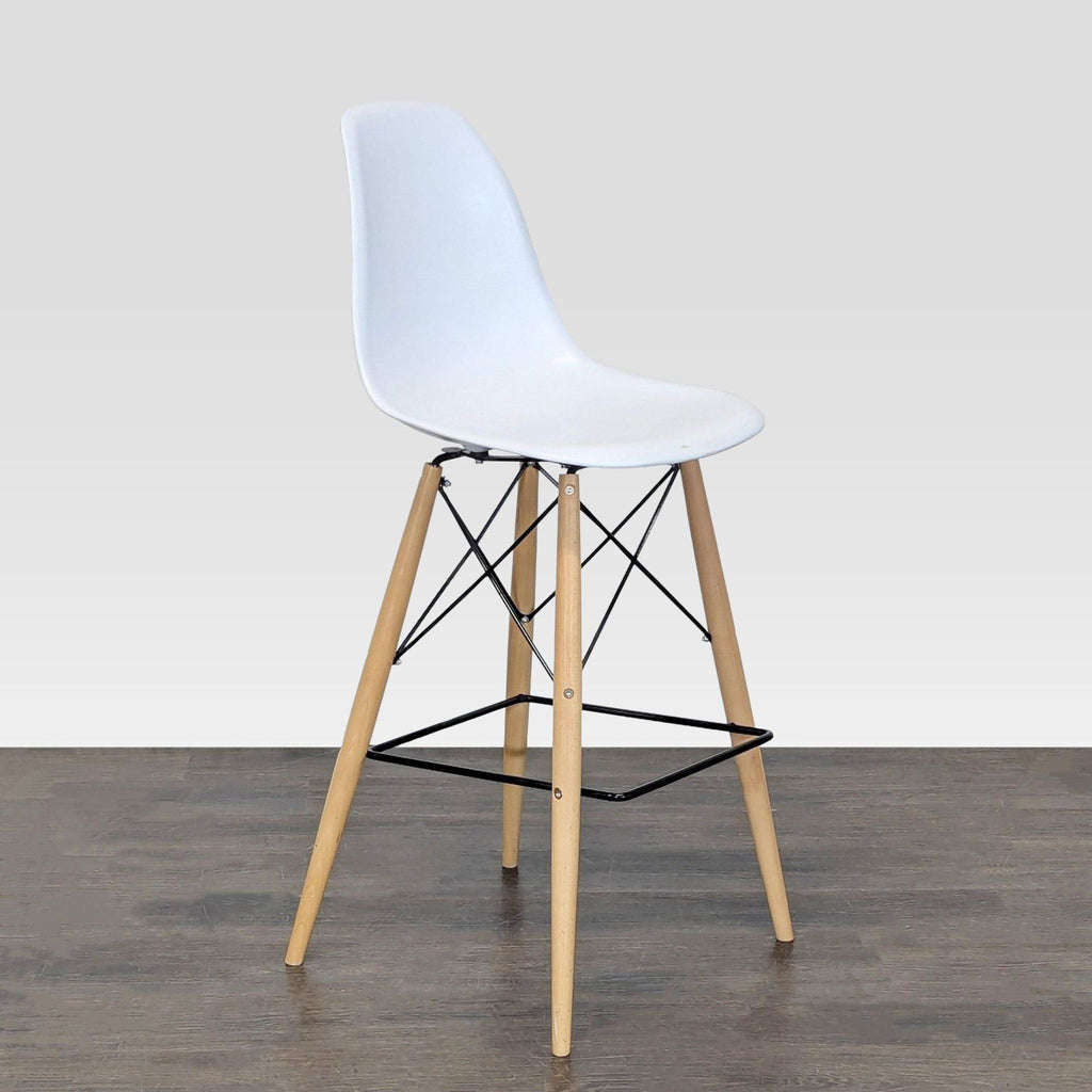 Modern dining chair with a contoured plastic seat and angled wooden dowel legs.