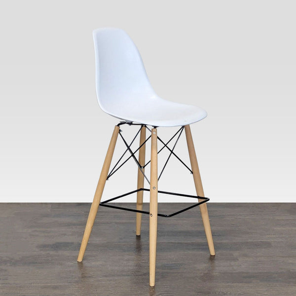 Modern dining chair with a contoured plastic seat and angled wooden dowel legs.
