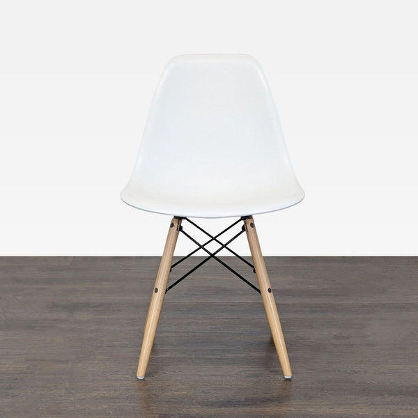 White plastic dining chair with wooden legs and metal bracing in mid-century modern style.