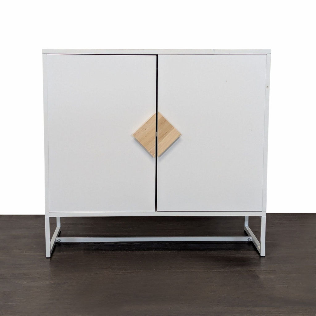 Modern white cabinet with wooden handles and metal base, includes two spacious interior shelves.  