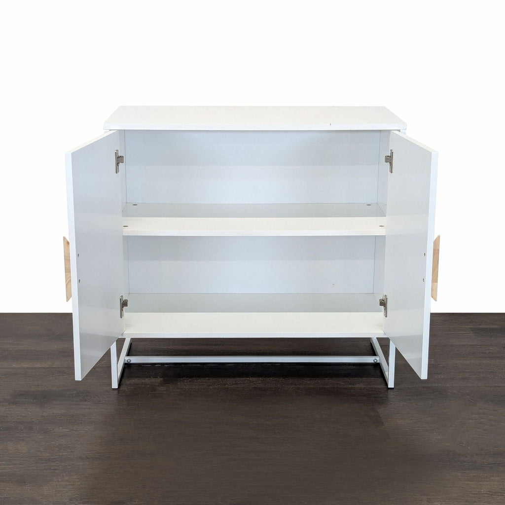 Sleek cabinet in white, highlighted by wood-accented handles and a contemporary metal base.  