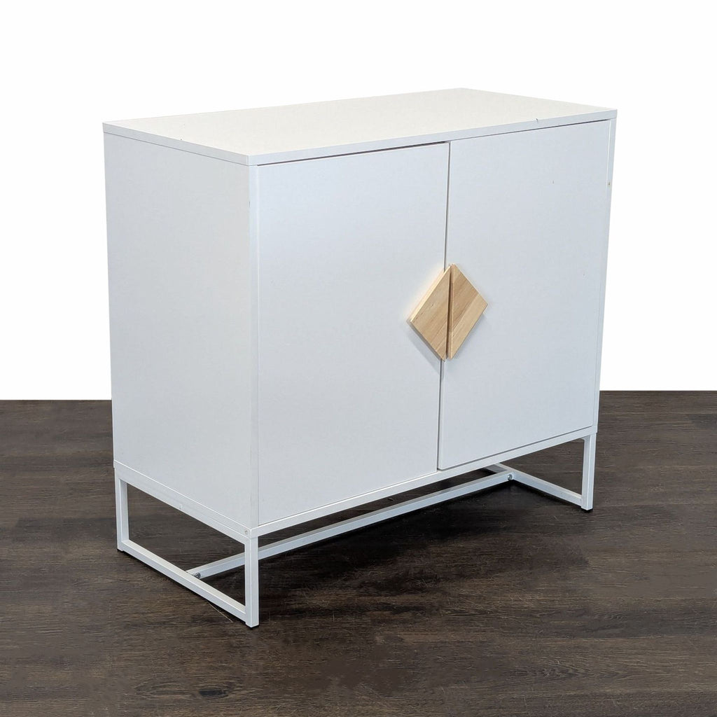 Contemporary white cabinet featuring wood detail on handles, metal legs, and two interior shelves.