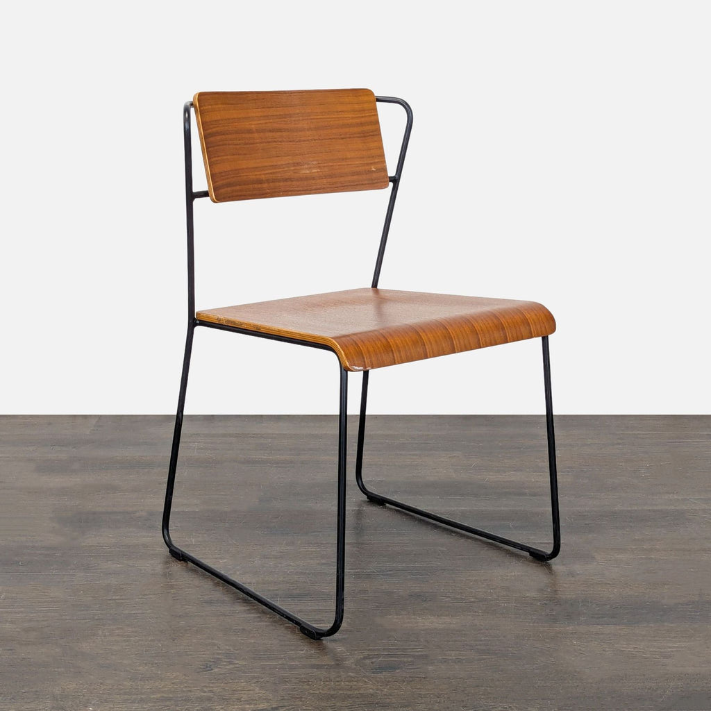 Dining chair with sleek steel wire legs and sculpted plywood seat, designed by m.a.d. Furniture Design.  