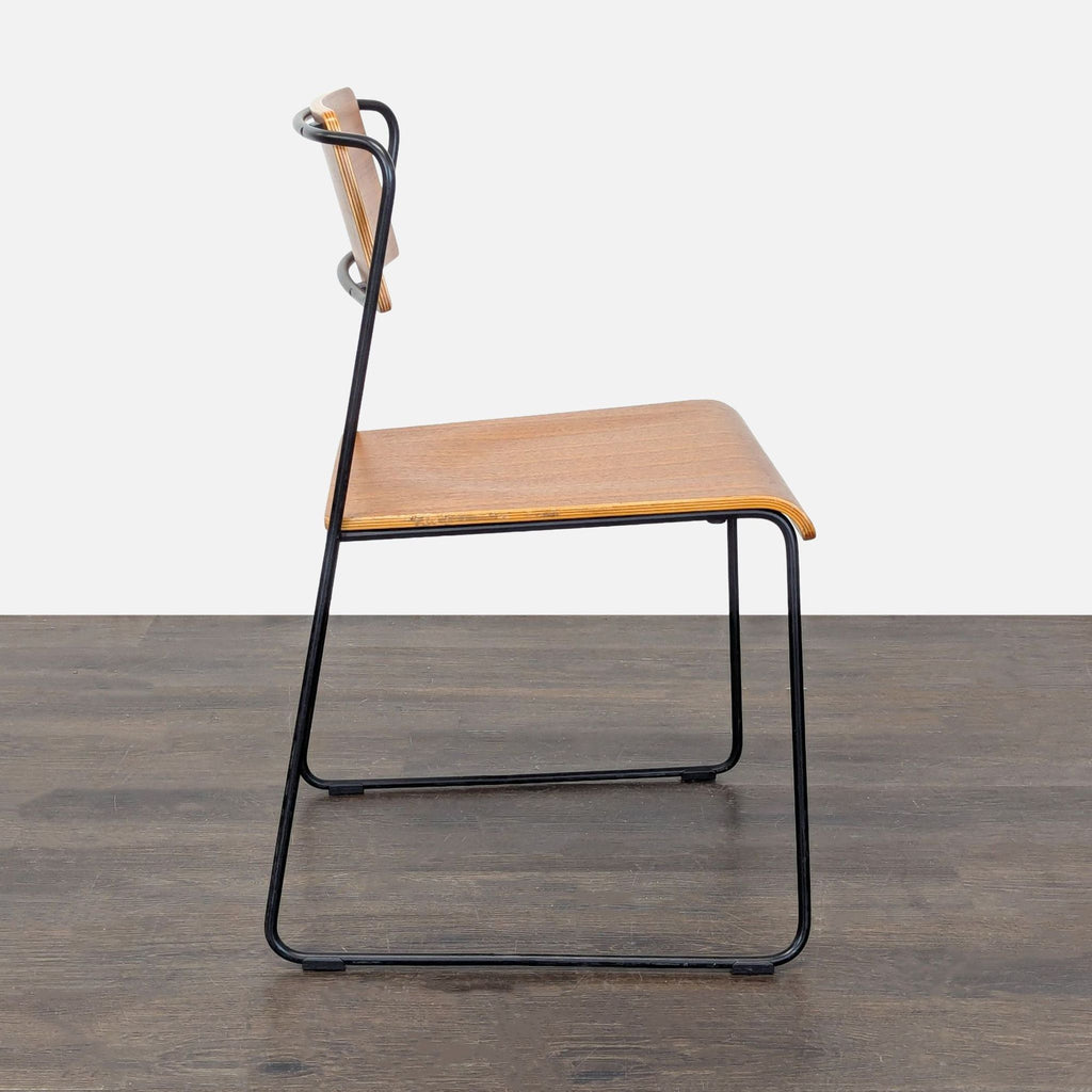 Modern dining chair with a smooth plywood seat and back, supported by a sturdy steel wire frame.
