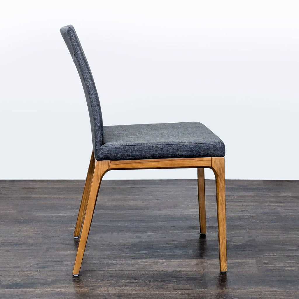Dining chair from New Pacific Direct with soft upholstery and sleek wooden legs, ideal for modern spaces.