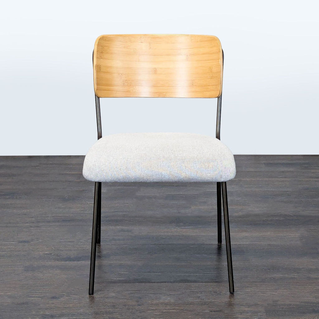 Metal dining chair with cushioned seat and wooden backrest by New Pacific Direct.  