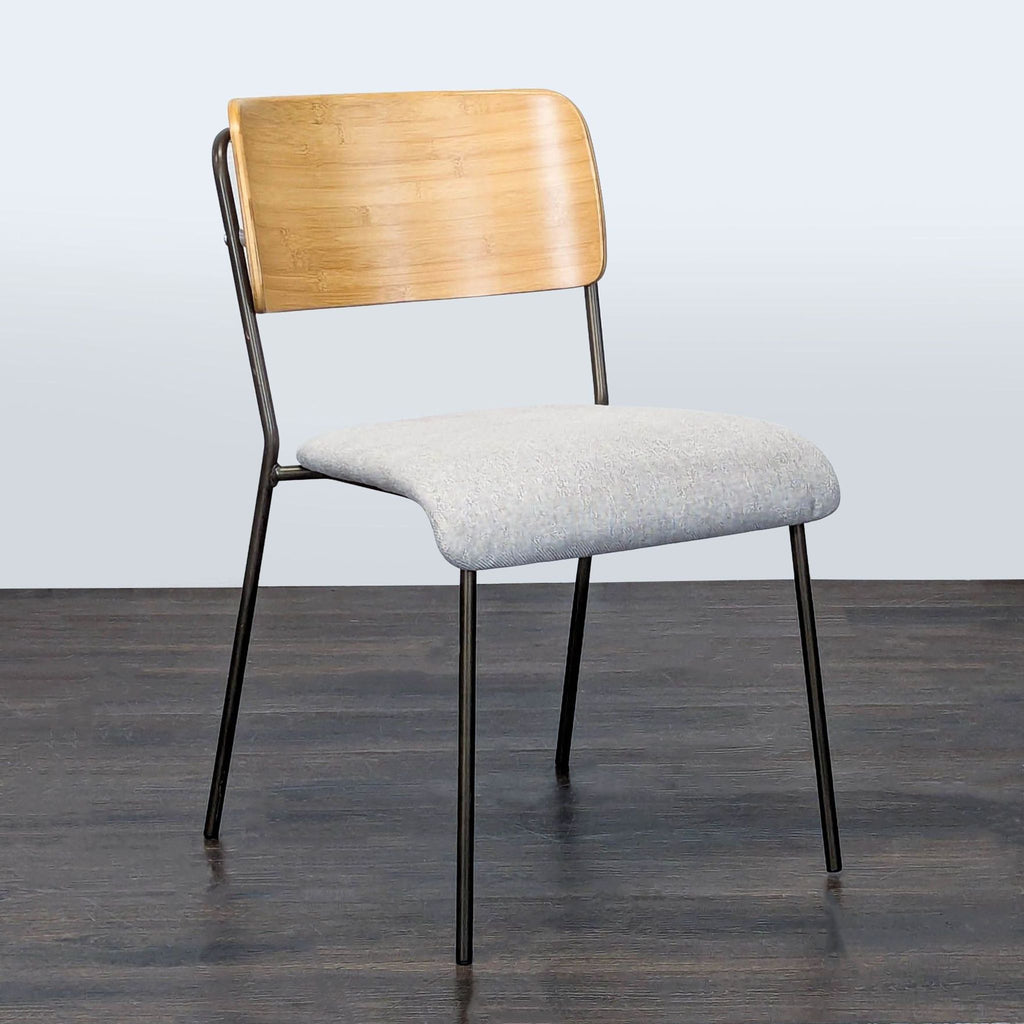Dining chair featuring a metal frame, upholstered seat, and a wood back; New Pacific Direct.  