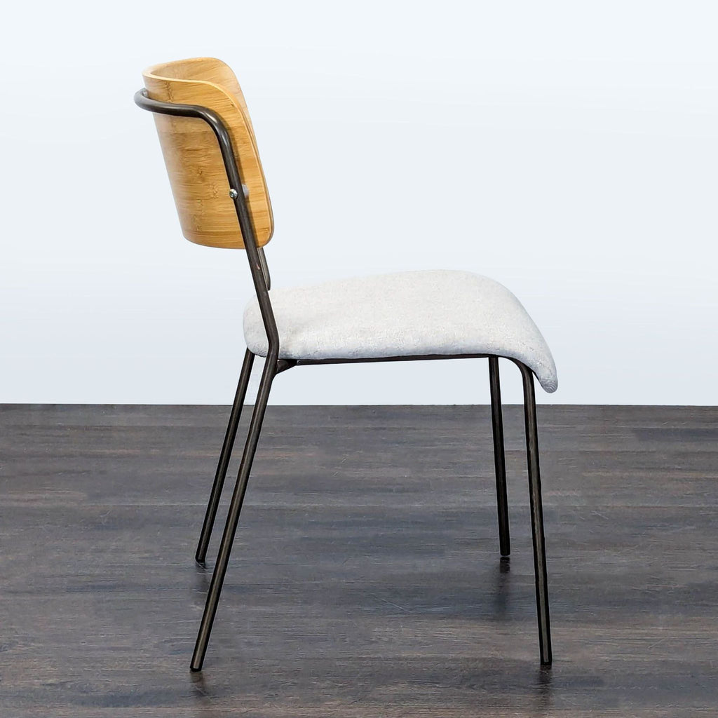 Modern dining chair from New Pacific Direct with metal legs, fabric seat, and wood backrest.