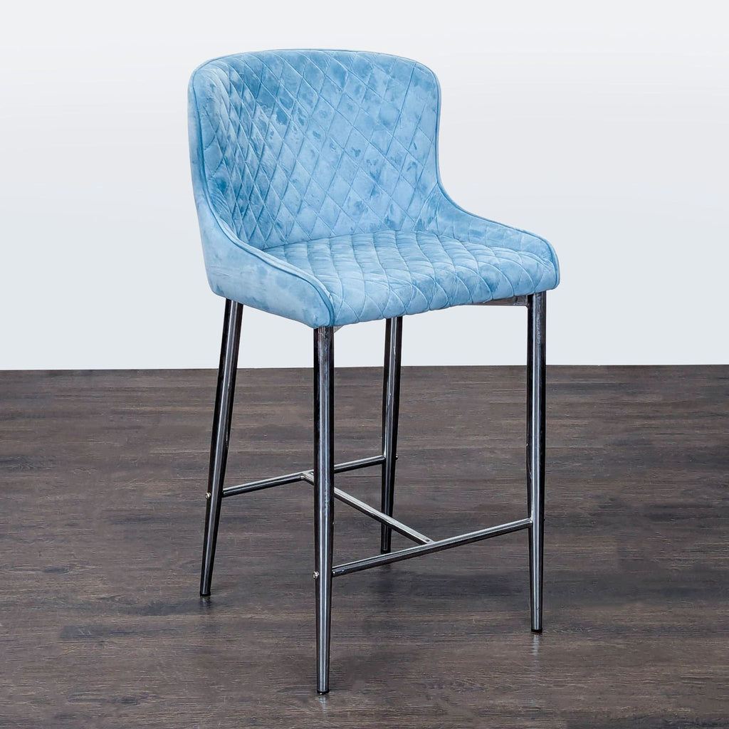 Contemporary bar stool featuring a soft blue quilted seat and shiny chrome legs for stylish seating.