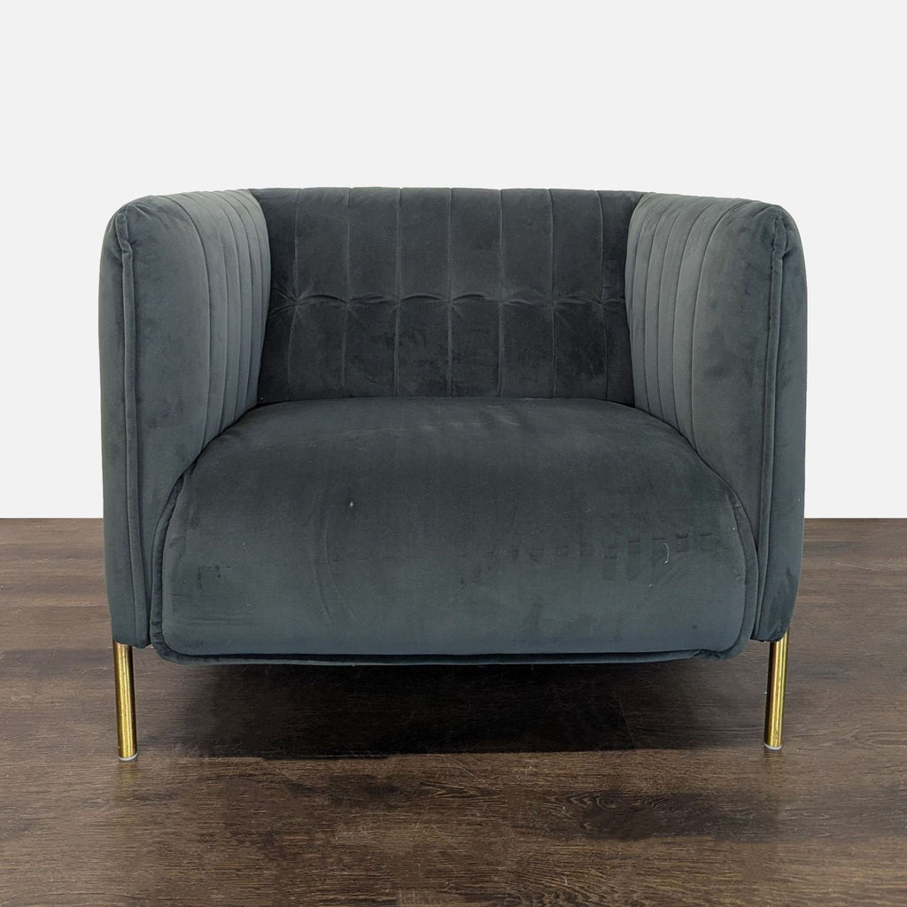 Modern dark grey velvet lounge chair with gold metal legs and boxy shape, ideal for living rooms.