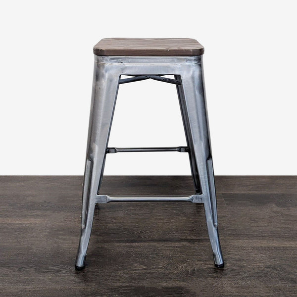 Industrial metal stool with square wooden seat, sturdy frame, and footrest, ideal for kitchens or bars.