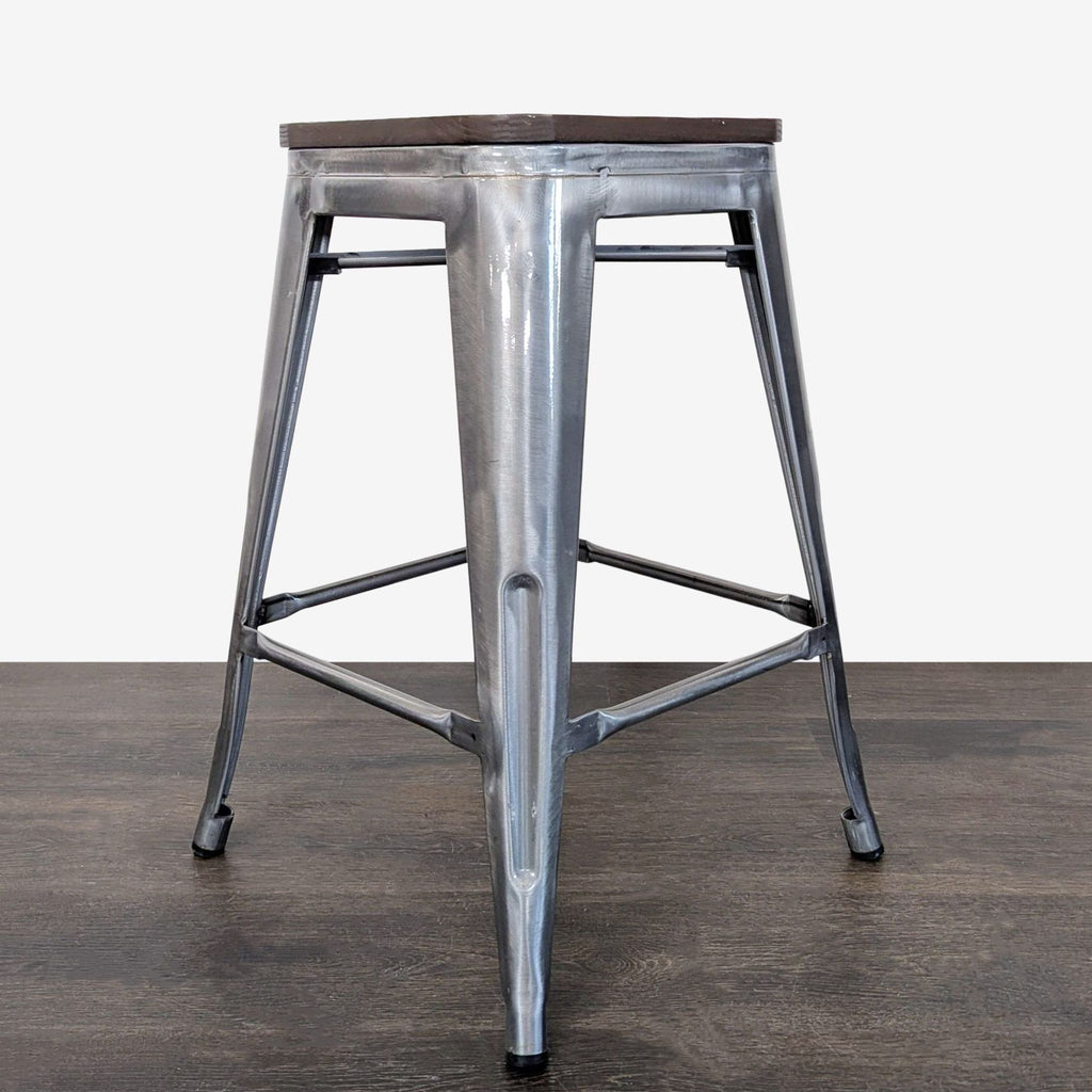 Modern industrial stool featuring a robust metal base, compact design, and a sleek wooden seat for versatile use.