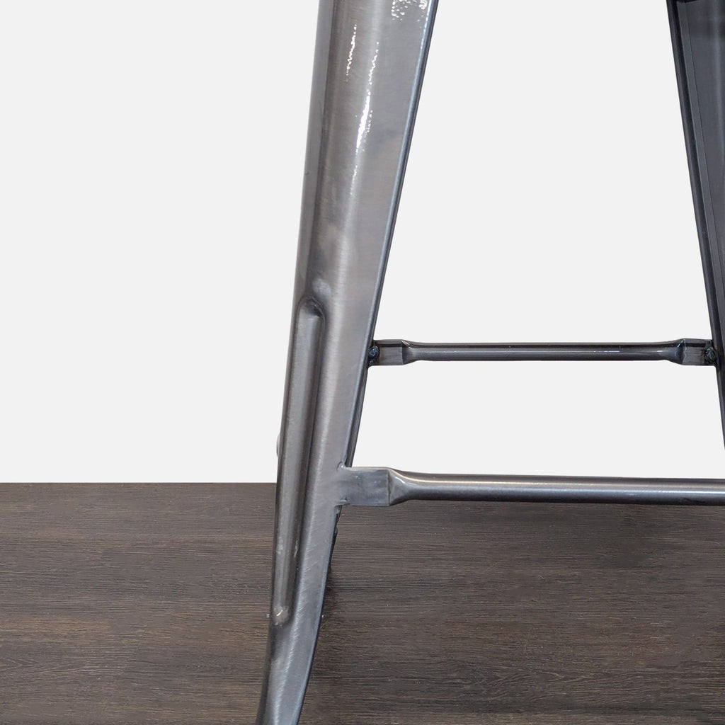 Durable metal-frame stool with a stylish wooden top, perfect for small spaces in homes or commercial settings.