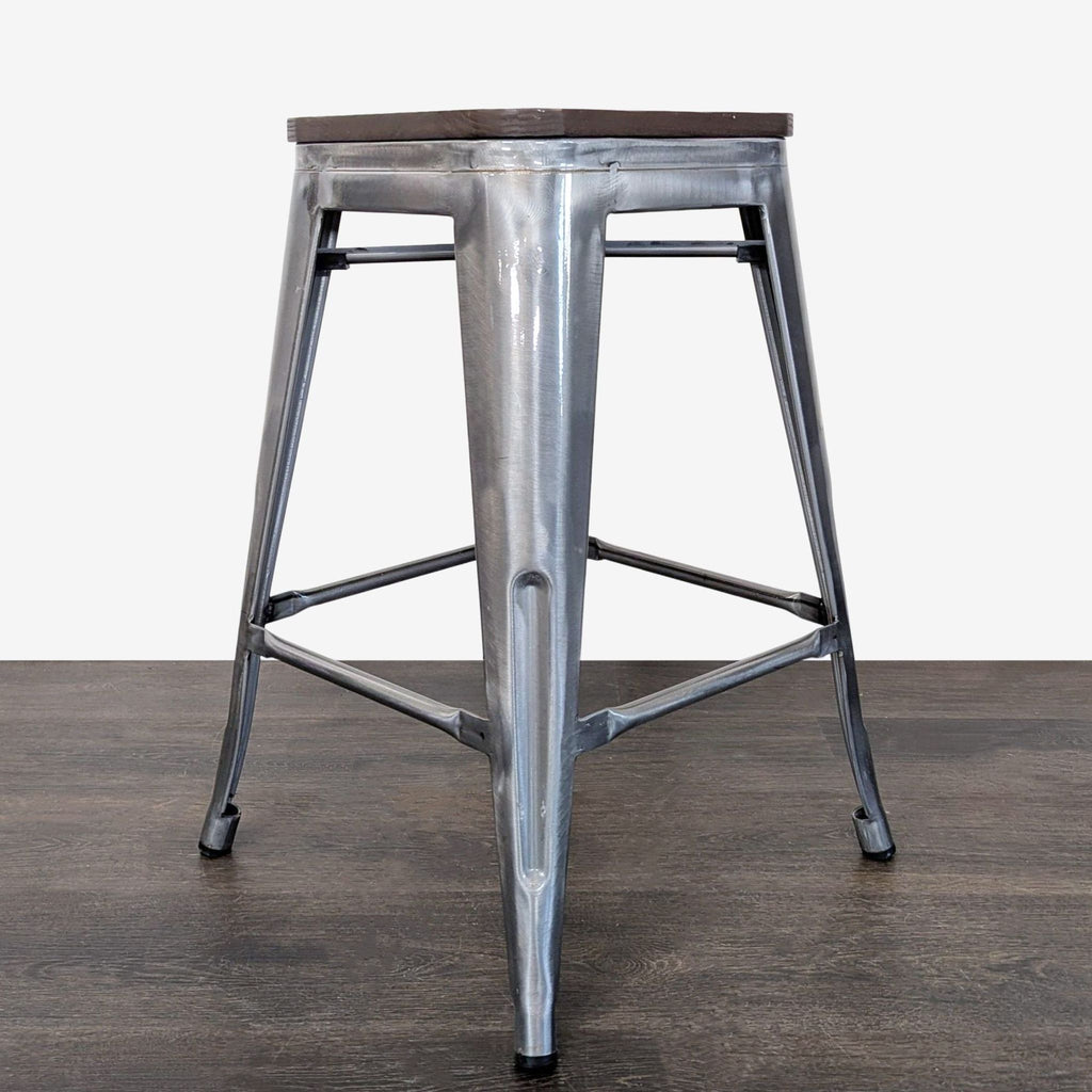Compact metal stool with sleek finish and sturdy construction, ideal for home or commercial spaces.