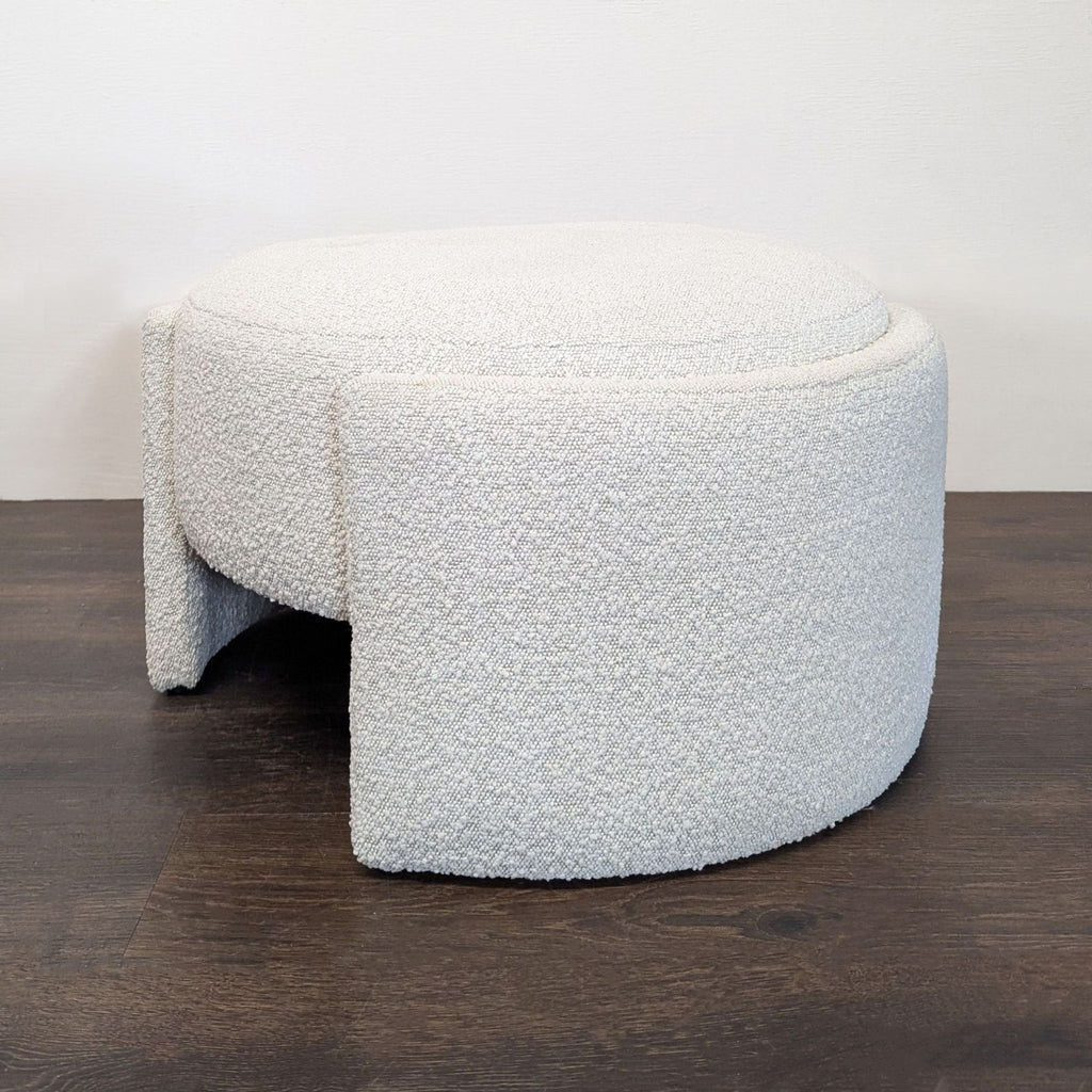 New Pacific Direct round ottoman with unique legs, offering a comfy seat or stylish footrest option.