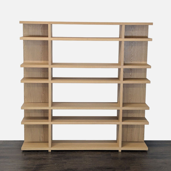 Modern West Elm bookshelf with open wooden shelves and a natural finish, ideal for books or decor.