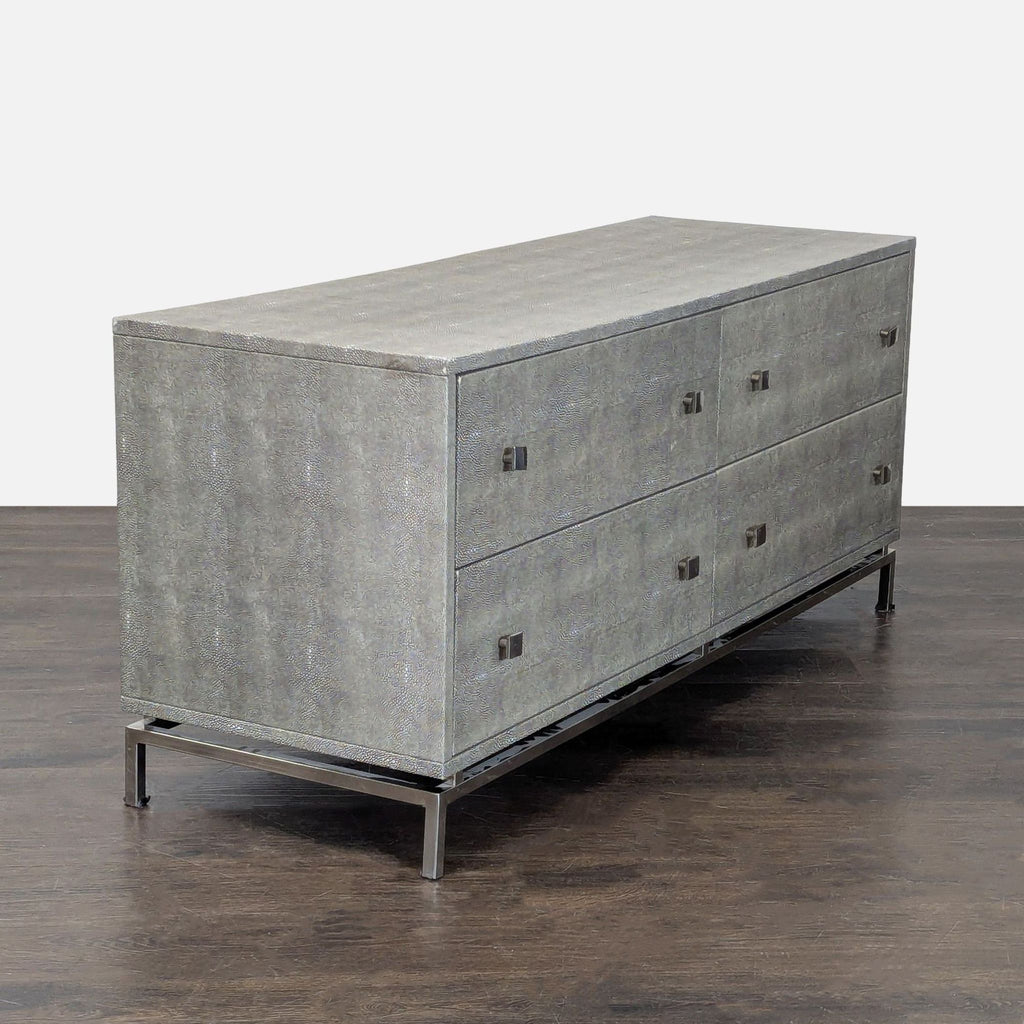 Modern grey CB2 dresser with metal legs and four roomy drawers, ideal for stylish bedroom or living room storage.