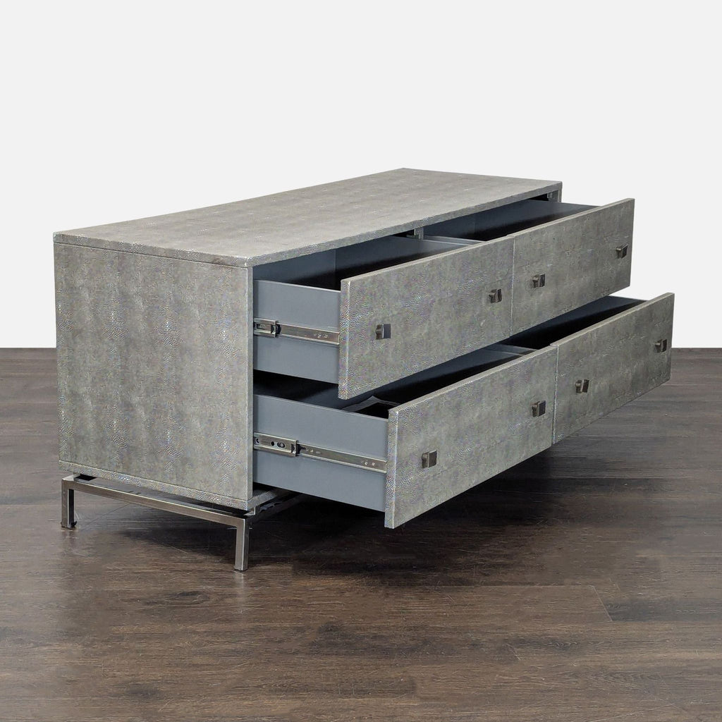 Modern CB2 dresser in grey, set on a contemporary metal base with four roomy drawers for practical storage.
