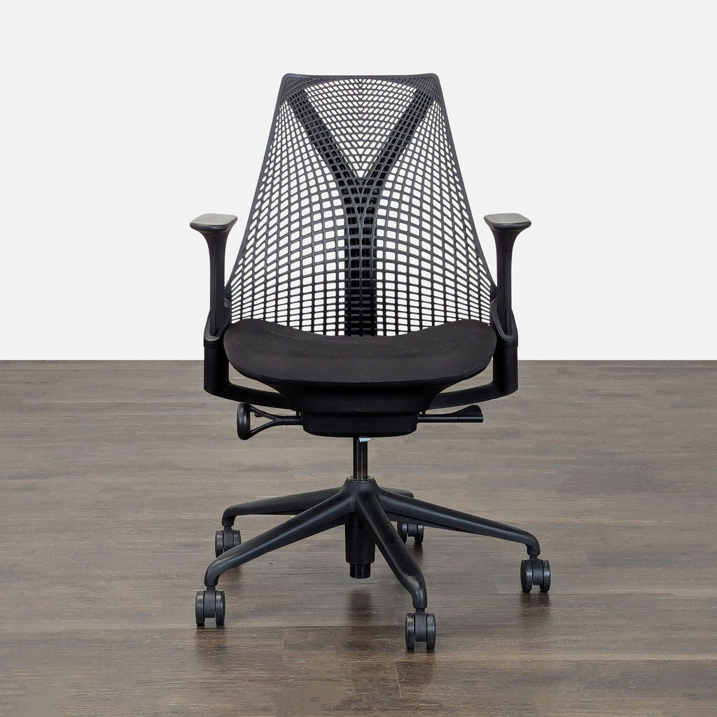 Herman Miller office chair with mesh back, adjustable armrests, and rolling base for ergonomic comfort.