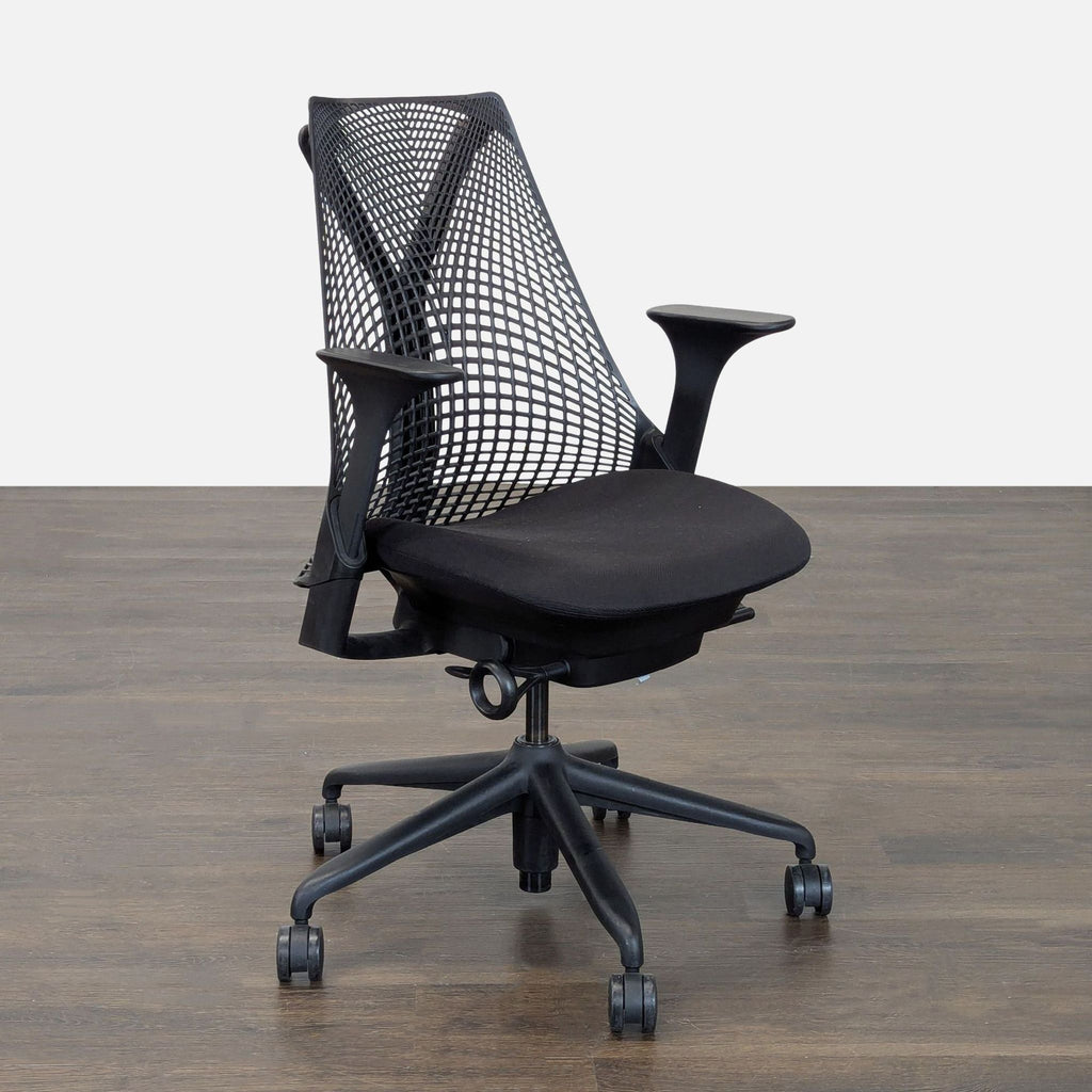 Black Herman Miller chair featuring a padded seat, mesh backrest, and supportive, adjustable design for workspaces.