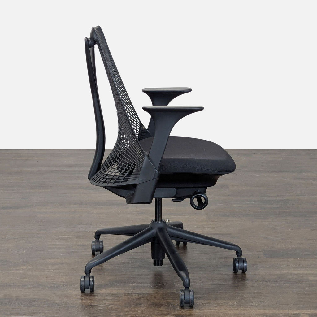 Ergonomic Herman Miller chair with breathable mesh, sturdy wheels, and customizable armrests for office use.