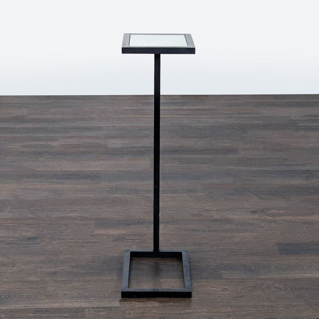 Sleek metal C-table featuring a clear glass surface, from Restoration Hardware.  